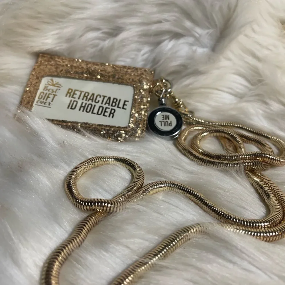Retractable ID holder gold glitter with detachable gold tone chain .